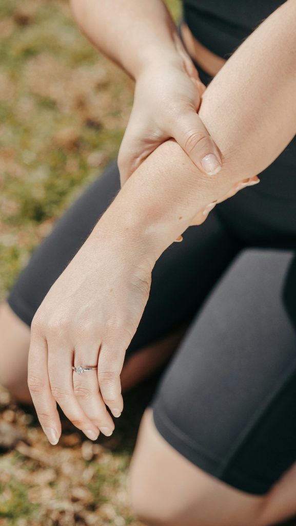 Close-up of a woman holding her wrist showing numbness and tingling typical of carpal tunnel syndrome